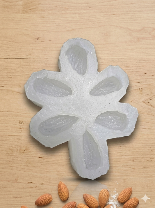 Badam Almond Candle Silicone Mold by Bloom Creations – 6-cavity white mold with real almonds displayed below on wooden surface