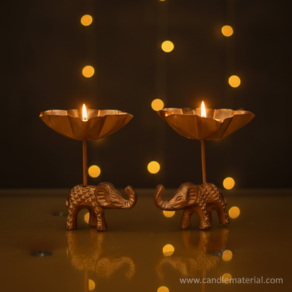 Elephant tall stem lotus diya holders with lit candles, dark moody background