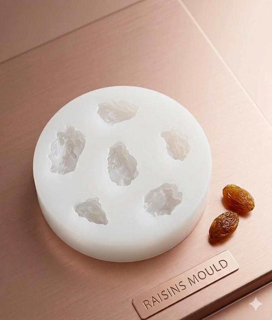 Kishmish Raisins Candle Silicone Mold by Bloom Creations – 7-cavity white round mold with real raisins beside it on rose gold surface