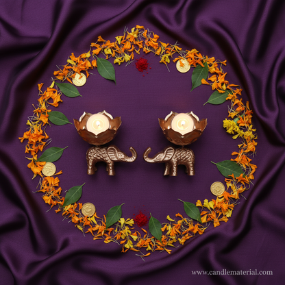 Flat lay of elephant lotus bud diya holders with puja styling and gold coins