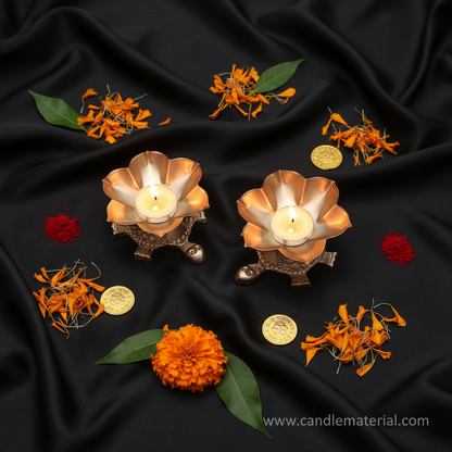 Flat lay of tortoise lotus diya holders with puja vastu styling and gold coins