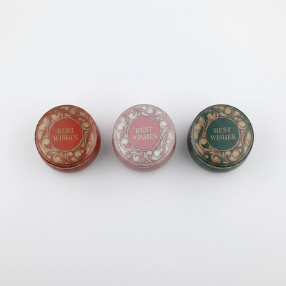 Best Wishes candle tins studio shot all three variants in a row