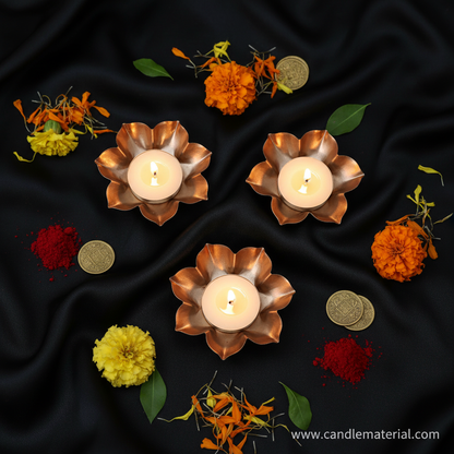 Flat lay of lotus petal diya bowls with puja styling and gold coins