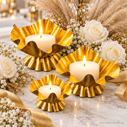 Set of three gold ruffled lotus petal candle vessels as wedding centrepiece with white roses and pampas grass