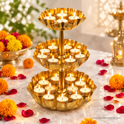 3-tier gold lotus petal tray stand with lit tealights on marble surface with marigold flowers