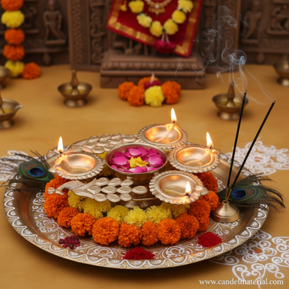 Gold compact twin peacock diya urli on pooja thali with floating petals marigold garland peacock feathers and rangoli