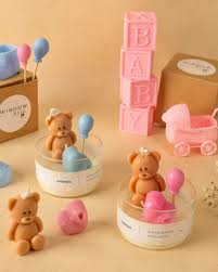 Multiple baby shower candles with teddy bear and balloon decorations
