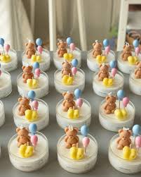 Finished baby shower candles with teddy bear and balloon toppers in glass jars