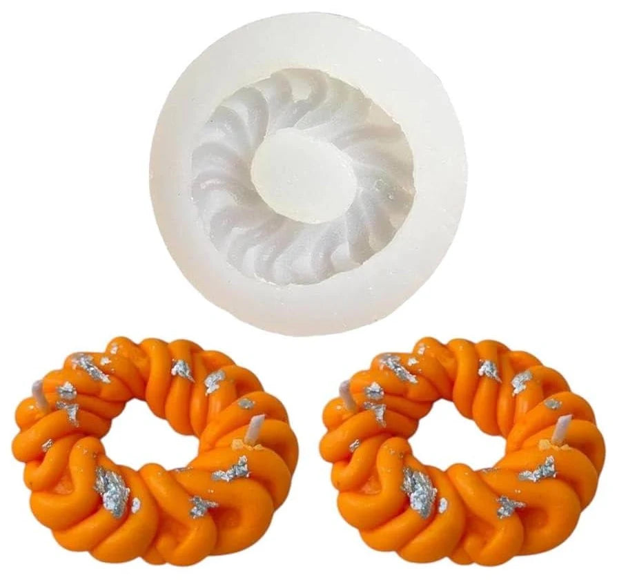 Imarti silicone mould with orange twisted ring candles and silver leaf