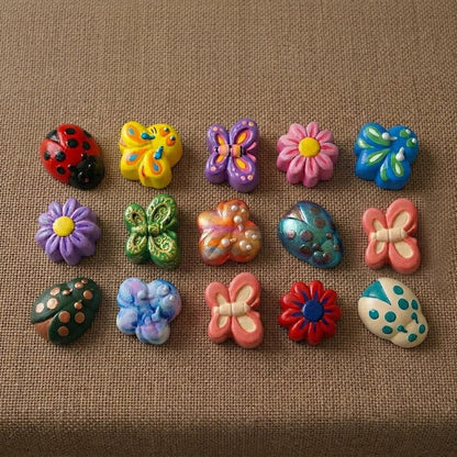 Colourful painted resin pieces cast from garden bugs and butterflies mould showing butterfly, ladybird and daisy designs