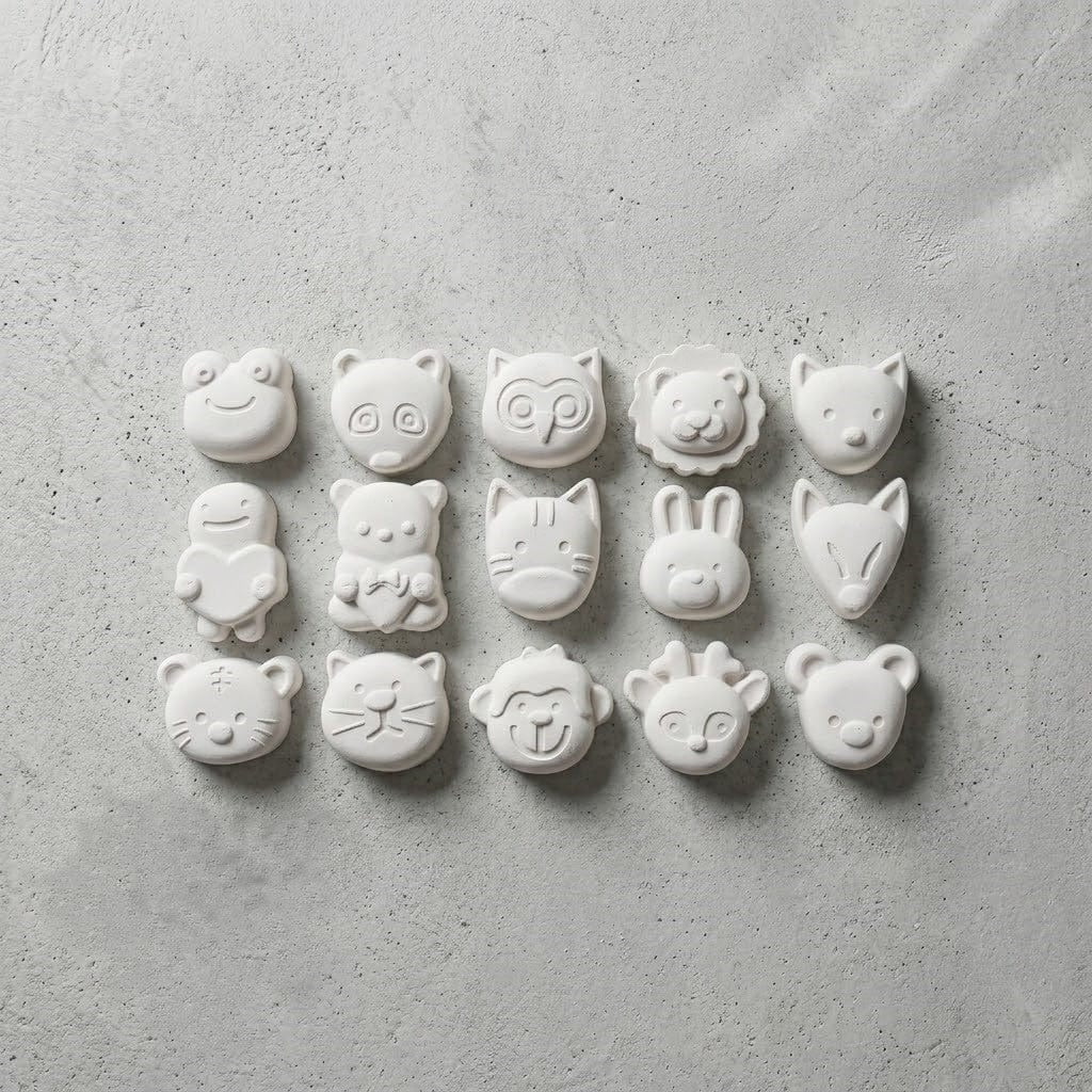 White wax melts cast from animal mould showing 15 woodland and safari animal face designs
