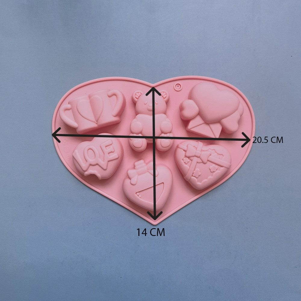 Six white wax melts cast from Valentine love heart silicone mould showing all 6 cavity designs